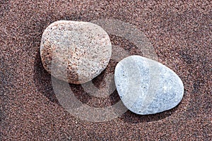 Beach red and yellow sand and sea stones