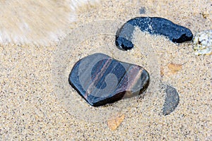 Beach red and yellow sand and sea stones