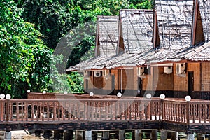 Beach resort with nipa hut cottages and forest as background