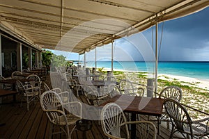 Beach restaurant during low season with passing rain cloud, Anguilla, British West Indies, BWI, Caribbean