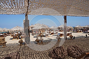 Beach restaurant, sea, sunbeds and rest in summer