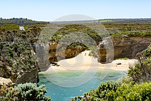 Beach between rock formations in bay Twelve Apostles, Australia, morning light at rock formation Twelve Apostles