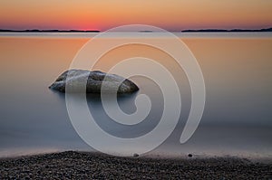 Beach with rock at sunrise