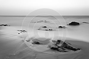 Timeless Beach With Rocks Long Exposure