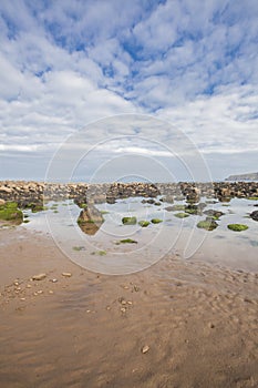 Beach with rocks in the sand at Cayton Bay, UK