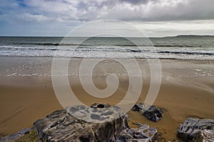 The Beach, Rocks, Sand, Waves And Clouds of South Beach, Tenby, Pembrokeshire, Wales, UK.