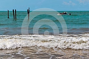 Beach, with rocks, waves and vegetation forming a beautiful maritime landscape.