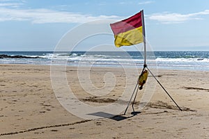 Beach safety flag on sunny day at seaside
