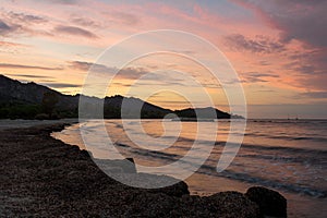 The beach at Saint Florent Corsica France  at sunset with mountains in the background . holiday destination