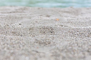 Beach sand blue sea water summer background with shallow depth of field