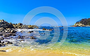 Beach sand blue turquoise water waves rocks panorama Puerto Escondido