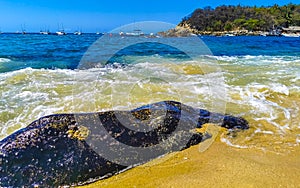 Beach sand blue turquoise water waves rocks panorama Puerto Escondido