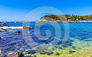 Beach sand blue turquoise water waves rocks panorama Puerto Escondido