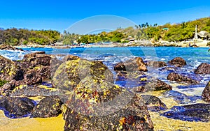 Beach sand blue turquoise water waves rocks panorama Puerto Escondido