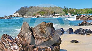 Beach sand blue turquoise water waves rocks panorama Puerto Escondido