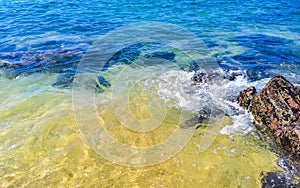 Beach sand blue turquoise water waves rocks panorama Puerto Escondido photo