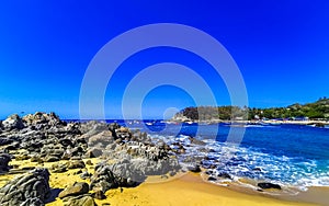 Beach sand blue turquoise water waves rocks panorama Puerto Escondido photo