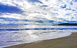 Beach sand blue water huge surfer waves Puerto Escondido Mexico