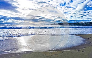 Beach sand blue water huge surfer waves Puerto Escondido Mexico