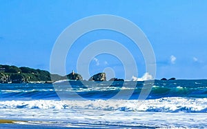 Beach sand blue water huge surfer waves Puerto Escondido Mexico