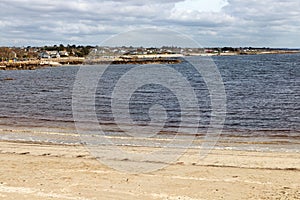 Beach with sand and buildings in Galway Bay