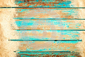 Beach sand on old wood plank in blue sea paint