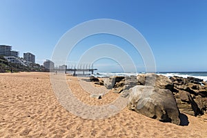 Beach sand rocks ocean waves blue coastal city skyline