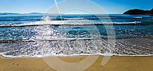 Beach sand, sea and blue sky with clouds. Beach and tropical sea.Turquoise sea.