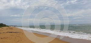 Beach with sand and sky is full of clouds ,sun is also blocked by clouds