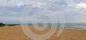 Beach with sand and sky is full of clouds ,sun is also blocked by clouds