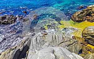 Beach sand blue turquoise water waves rocks panorama Puerto Escondido photo