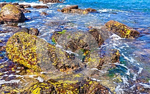 Beach sand blue turquoise water waves rocks panorama Puerto Escondido photo