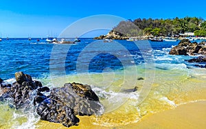 Beach sand blue turquoise water waves rocks panorama Puerto Escondido photo