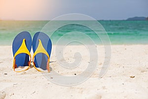 Beach sandals on the sandy sea coast, summer concept holiday and