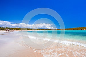 Beach scene with clear blue water, blue sky and sandy shore seen from Puerto Rico