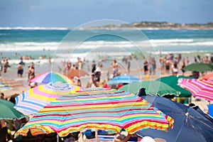 Beach scene with colorful umbrellas and people on the beach