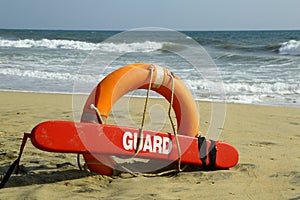 A beach scene with lifeguard equpments.