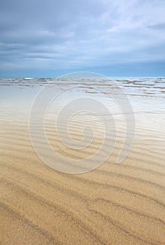 Beach scene with sand ripples and beautiful sky