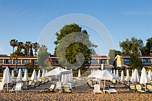 Beach scene in Side Turkey with empty umbrellas and sun loungers. Vacation at the sea. Summer holidays