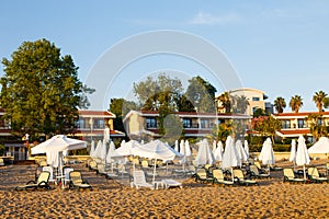 beach scene in Side Turkey with empty umbrellas and sun loungers. Vacation at the sea. Summer holidays.