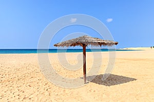 Beach scenery with parasol in Boavista, Cape Verde