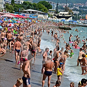 The beach, the sea, a lot of people vacationing.