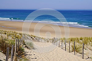 Beach sea with sand dunes and sandy fence access on atlantic ocean in gironde France southwest