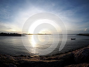 Beach sea scene view with deep blue sky and brown beach sand and stones