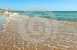 beach and sea in summer. Close up of waves of the sea. Texture of bubbles. Summer background.