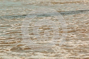 beach and sea in summer. Close up of waves of the sea. Texture of bubbles. Summer background