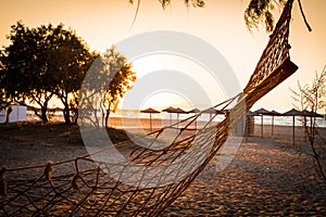 Beach and sea view with empty hammock at sunset