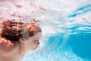 Beach sea and water fun. Child swim and dive underwater in the swimming pool.