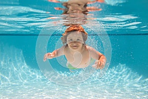 Beach sea and water fun. Young boy swim and dive underwater. Under water portrait in swim pool. Child boy diving into a