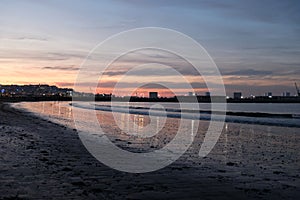 Beach and sea waves at colorful sunset. In Tangier Morocco